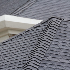 edge of Roof shingles on top of the house, dark asphalt tiles on